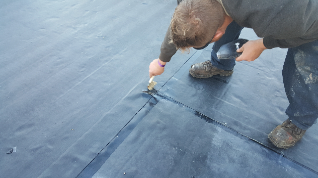 Installing and fully adhering the new EPDM.